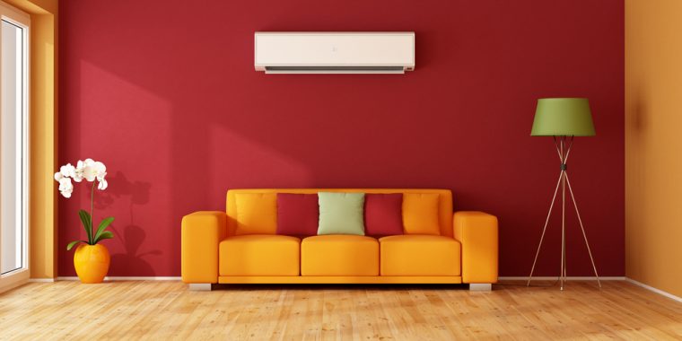 An air conditioning unit above a sofa in a colourful living room
